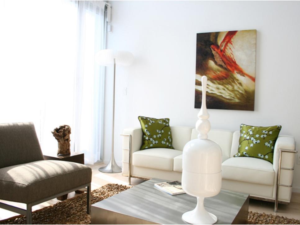 Living Room with White Loveseat and Abstract Artwork