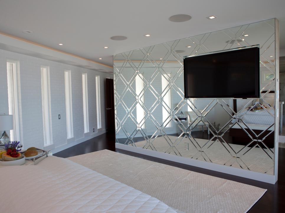 Mirrored Accent Wall With Inset TV in Bedroom