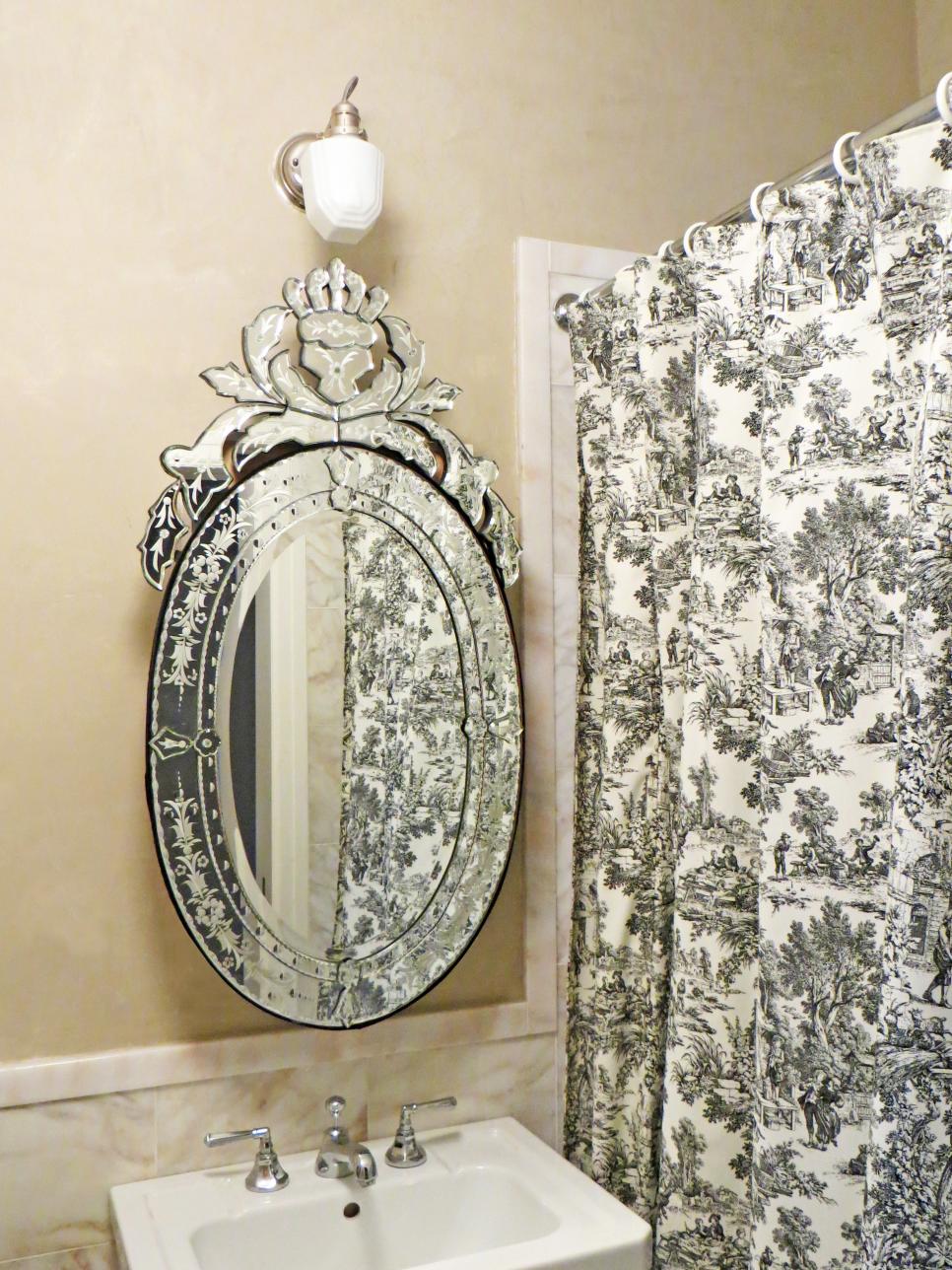 Neutral Bathroom With Toile Shower Curtain and Ornate Oval Mirror
