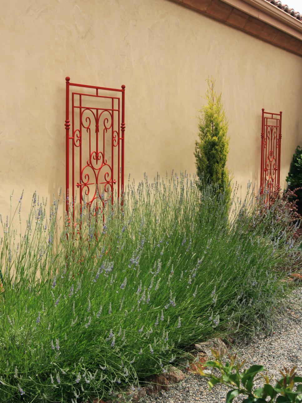 Mediterranean Exterior With Flower Bed and Red Accents