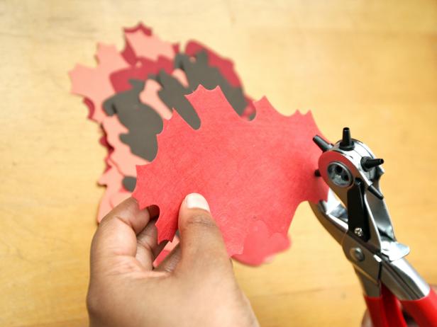 Using a hole punch, make a hole at the base of each leaf.