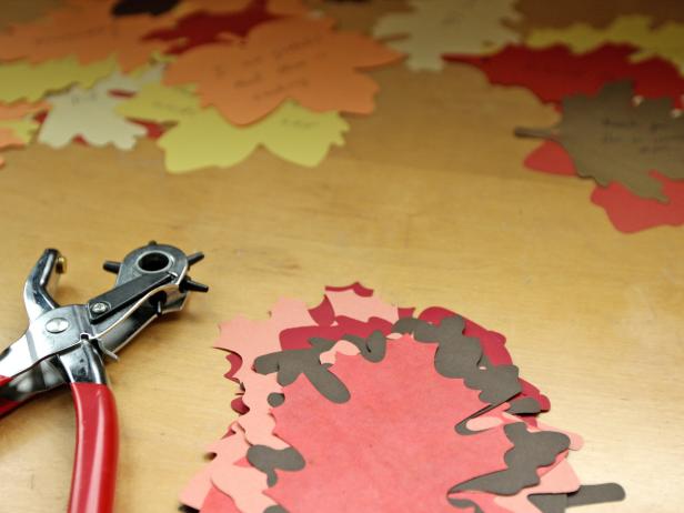 Look for a colorful mix of paper die-cut leaves in fall hues of orange, red, yellow and brown. The more variety in color and shape, the better your tree will look.