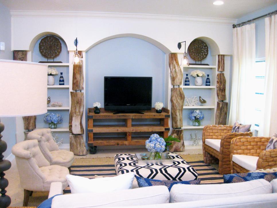 Light Blue Living Room With White Bookshelves Lined in Driftwood