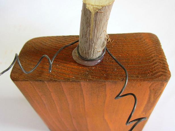 Wrap the curled wire around the pumpkin stem to hold it in place.