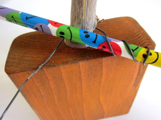 Cut a piece of wire, then curl the ends by bending them around a screwdriver or pencil.