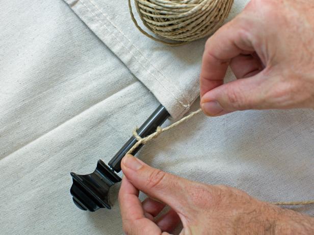 Add a hanger by tying twine on to rod and knotting it onto each end of the rod.