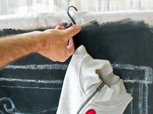 Place S-hooks or stocking hooks over the drapery rod, then hang up stockings on the finished faux chalkboard mantel.