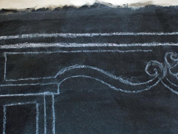 Use chalk to draw the silhouette of a mantel on the faux mantel holiday hanging.