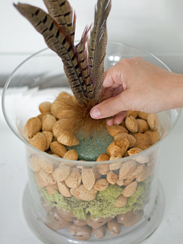 Use a wire cutter to shorten the length of the pheasant feather picks, if necessary. Insert picks into the foam, creating a full arrangement.