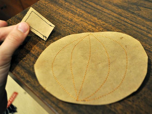 Attach separate sewn stem to the pumpkin treat pouch after filling the inside with candy.