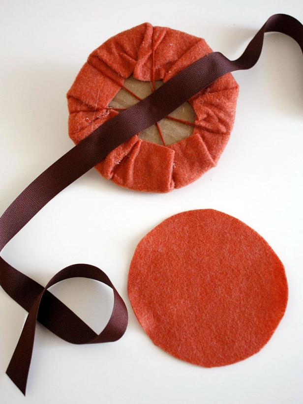 Cut about 1 1/2 yards of ribbon and lay it across the middle.