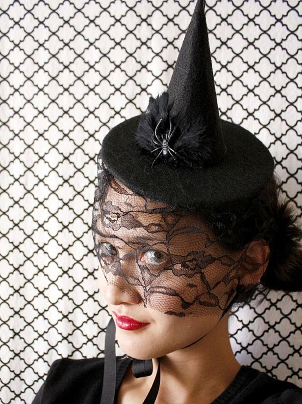 A strip of lace along the underside of the witch's hat resembles a veil for a spooky effect.