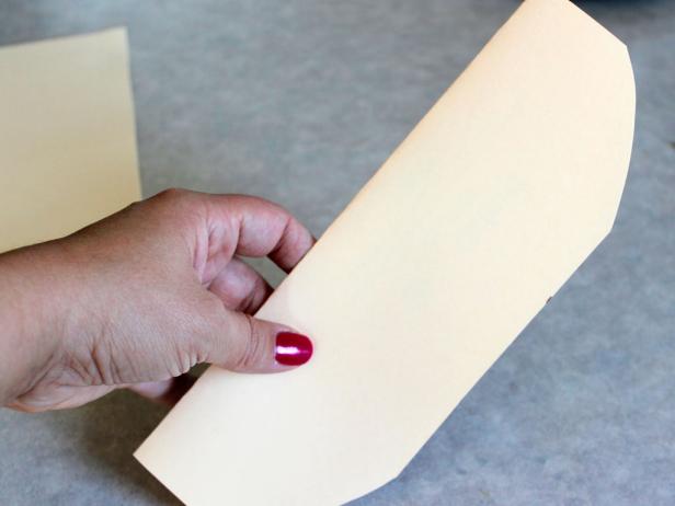 Then fold your rectangle in half to cut the corners, making them rounded. (It doesn't have to be exact.)