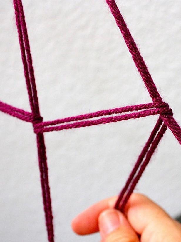 Cut a very long strand of yarn for each section — longer than you think you'll need. Fold it in half and start the ring with a simple loop knot. Then take the yarn around to each arm and simply loop it around. You don't need to tie knots — this is fast and easy. Don't try to be accurate and precise. It's better to look wonky here and there. When you get back around to beginning of the ring, tie the end with a knot, cut off the excess and start over on the next ring.