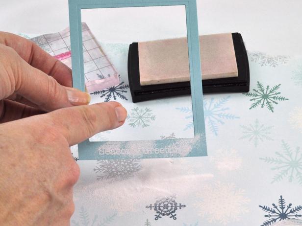 Using watermark ink, stamp sentiment onto bottom of frame then sprinkle white embossing powder onto watermark ink.