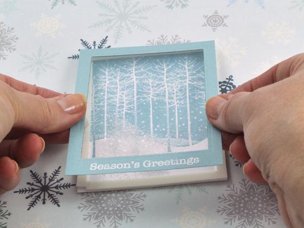 Carefully place window frame on top of the shaker base and burnish edges for snow shaker holiday card.