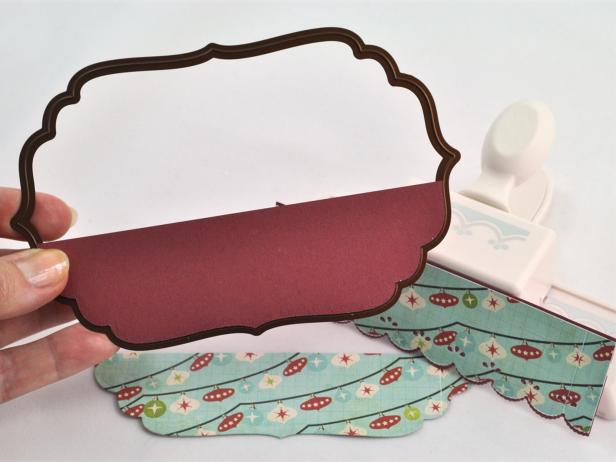 From coordinating piece of patterned paper, cut trim piece and mat layer to decorate card front.
