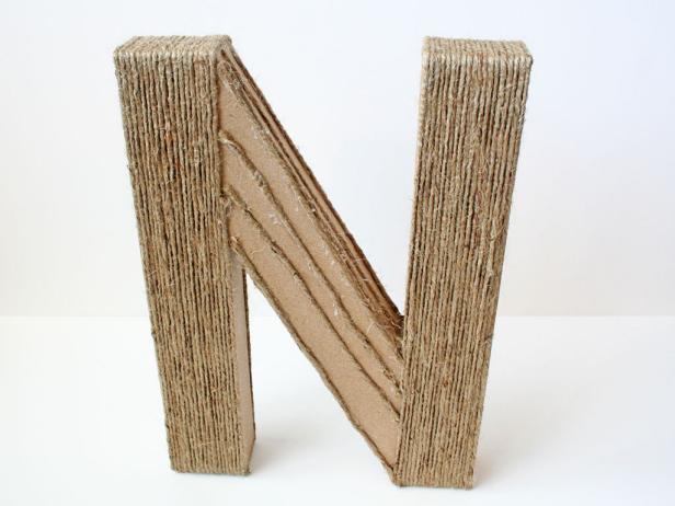 Stop with the jute once you get to the corner where the slanting part meets the straight part of the N. Then, start wrapping the middle part of the N with the other roll of jute.