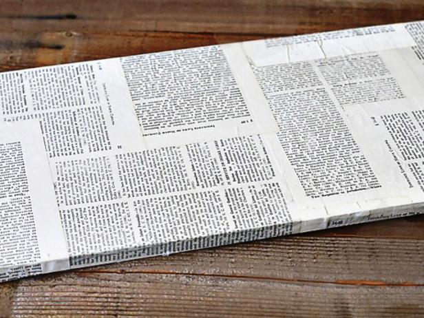 Layer the pages from an old book on the board and brush each one with a thin layer of Liquitex Matte Medium, which will act as glue. Continue to add the pages to make an interesting background, creating a collage.