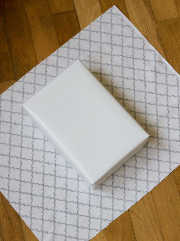 Cutting Fabric to Wrap Gift Box Patterned Fabric and White Gift Box