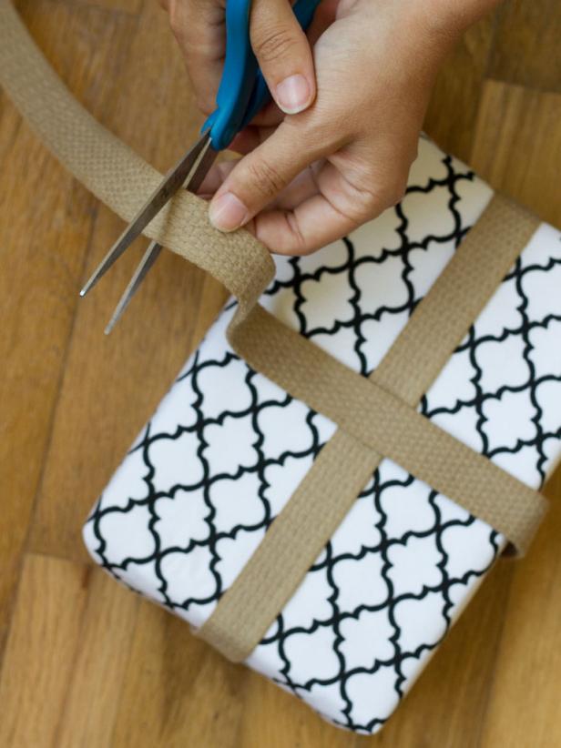 Adding Ribbon to Gift Wrap Cutting Ribbon on Gift Box