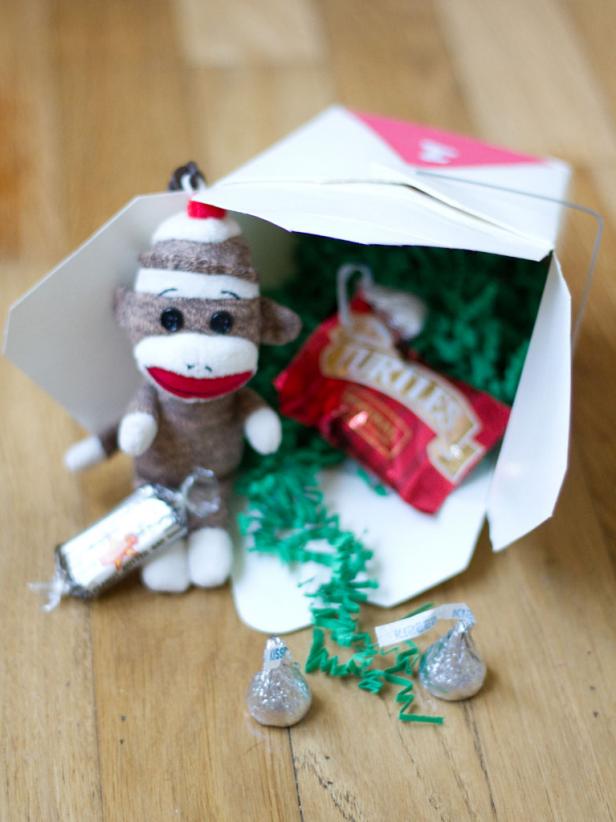 Fill each box with paper gift filler, small toys and candy. Use clear tape to seal the top of each box shut.