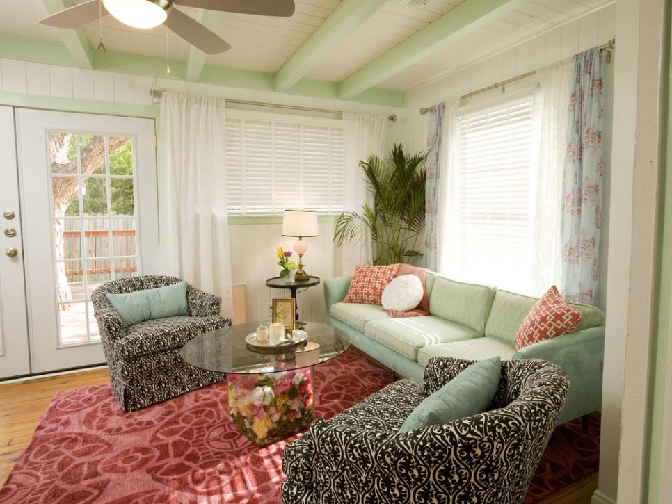 Green Living Room With Red Area Rug and White Curtains