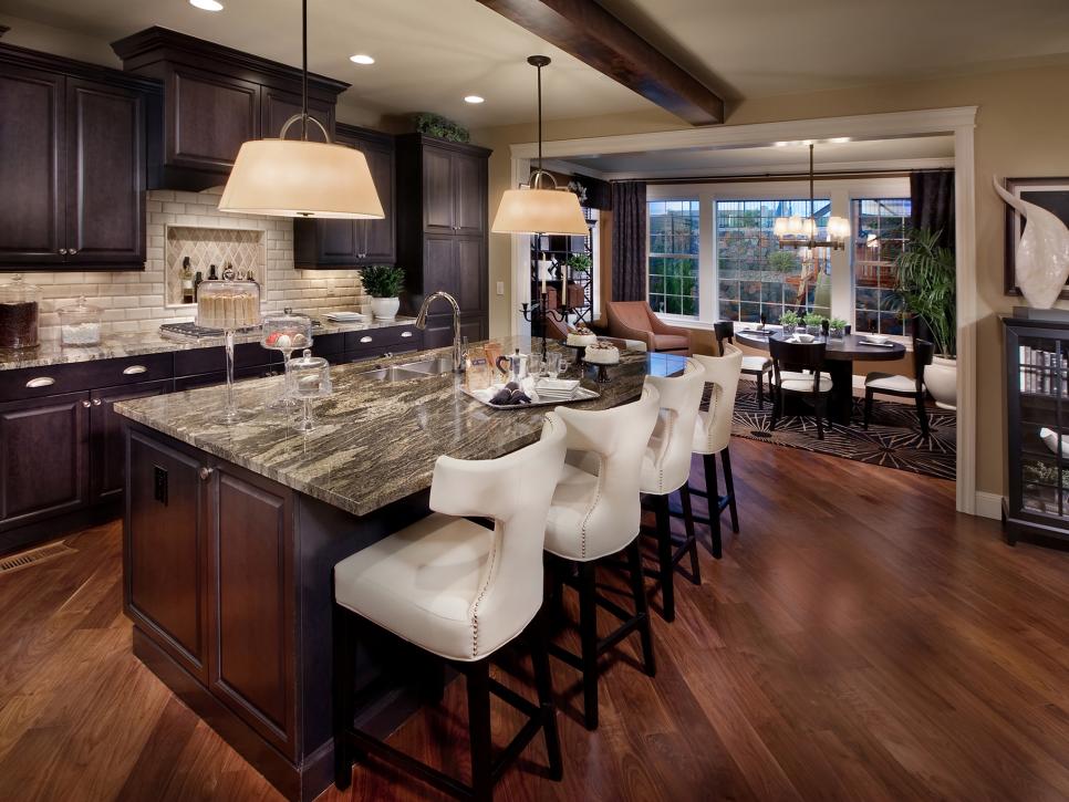 Neutral Kitchen With Large Island and Four White Barstools 