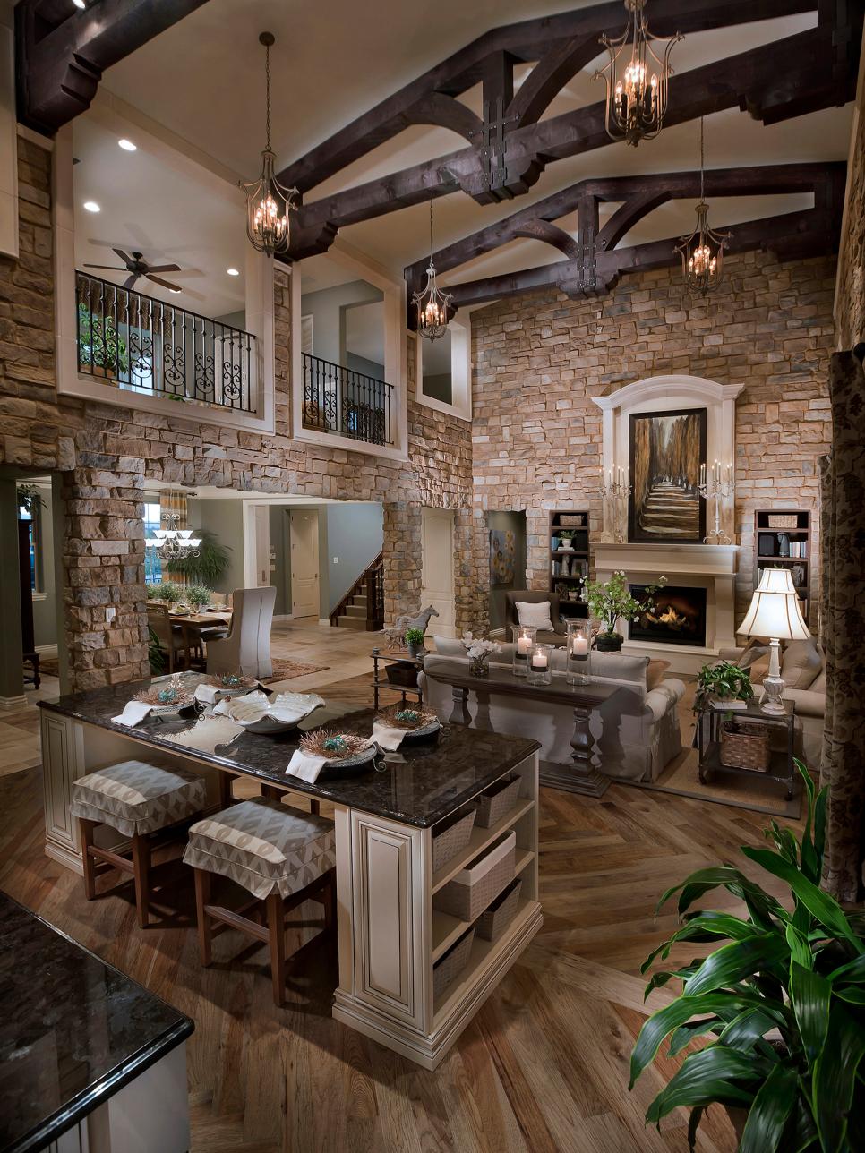 Two-Story Stone Great Room With Timber Trusses & Neutral Furnishings