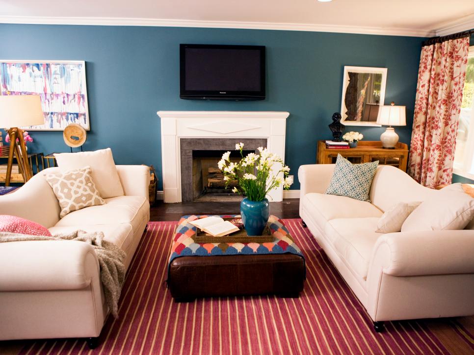 Family Room With Blue Walls, White Couches and Red Striped Rug