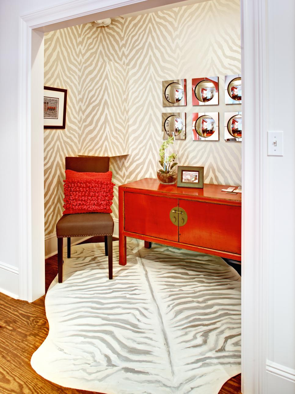 Eclectic Nook With Zebra-Print Walls and Rug Eclectic Nook With Animal Print Walls, Rug and Bright Red Console Table
