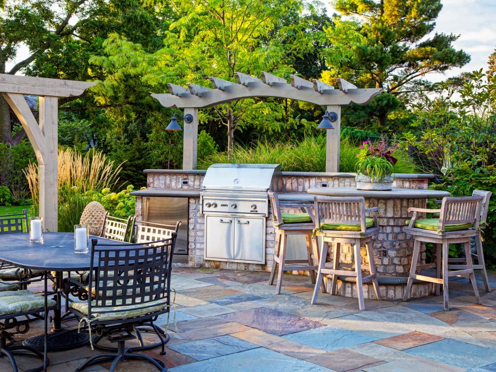 Outdoor Kitchen With Brick Island, Stainless Grill and Barstools