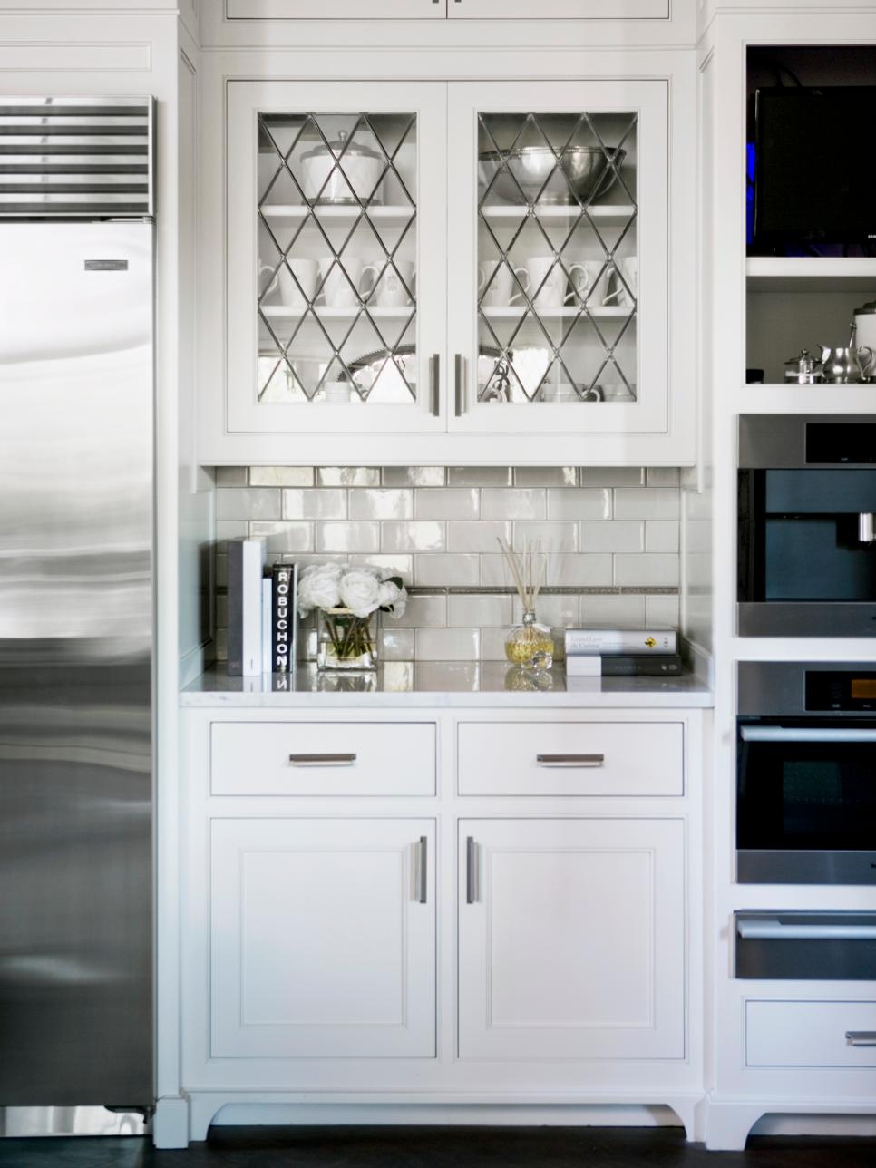 White Kitchen Nook with Glass-Front Cabinets Glass-Front Cabinets Above Subway Tile Backsplash in Kitchen Nook