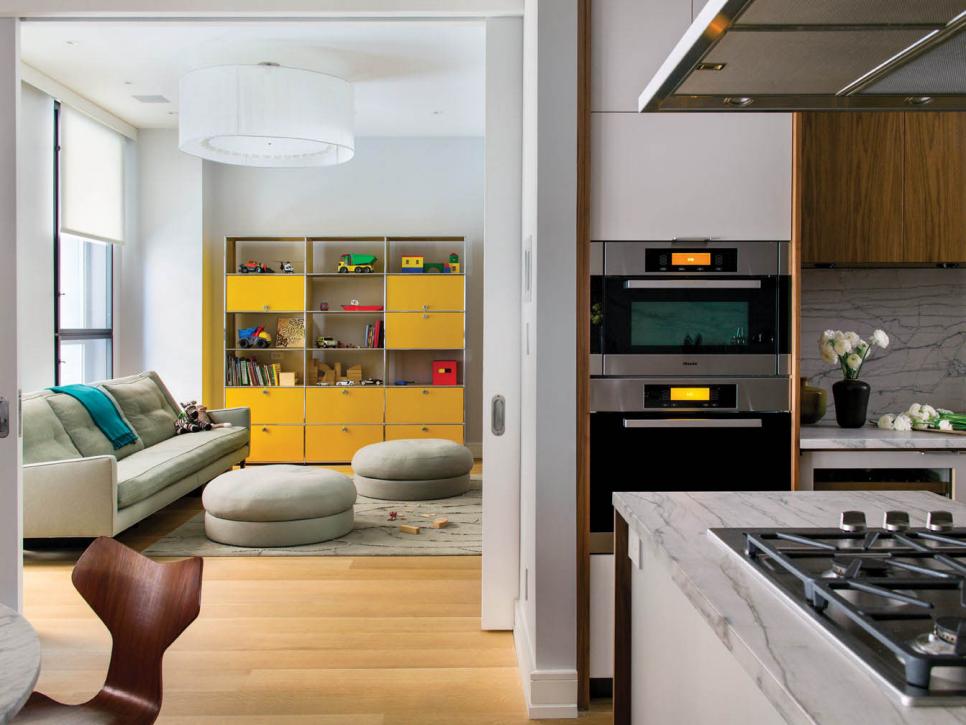 Dual View of Contemporary Kitchen and Living Room in City Apartment