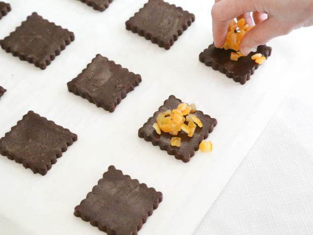 Evenly divide candied orange between the cut dough squares.