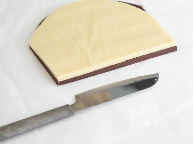 Cut each dough in half and stack one half vanilla dough on top of one-half chocolate dough so that the straight cut edges line up.