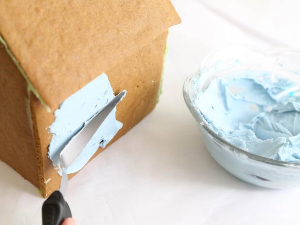 Cover the front, back and sides of house with icing using a small offset spatula.