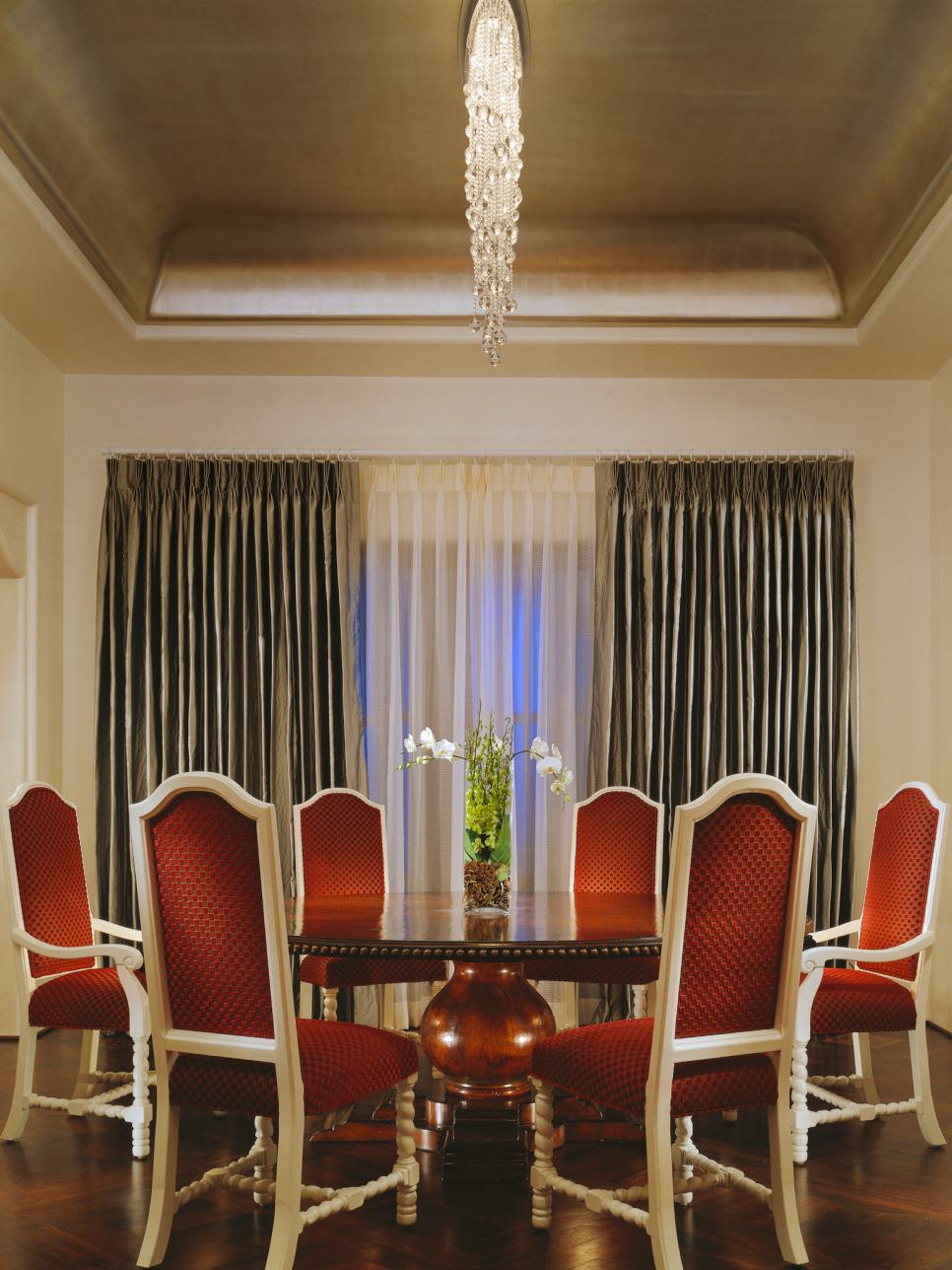 Dining Room With Traditional Round Dining Table and Red Chairs