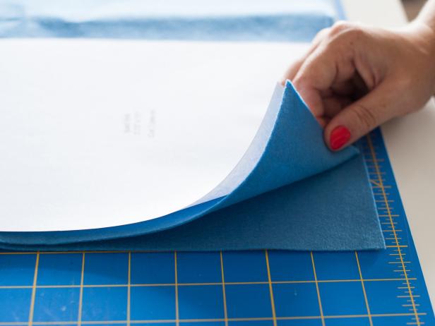 Download then cut out the patterns (http://hgtv.sndimg.com/HGTV/2013/10/30/original_Michelle-Edgemont-felt-case-patterns.pdf) you plan to use for your DIY case. Layer two pieces of felt and the felt pattern together.