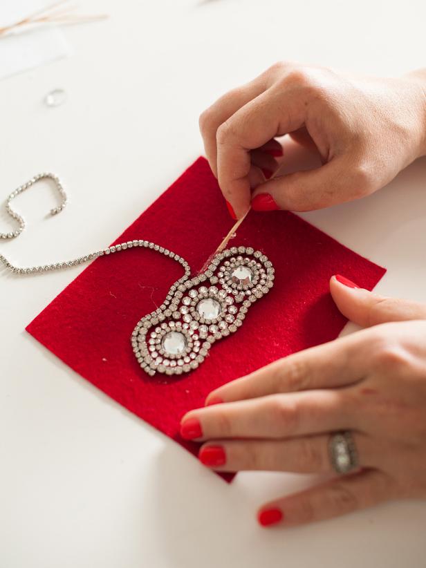 Finish with two rows of rhinestone trim. Apply glue to the back of the trim and tightly wrap it around the other circles, using a toothpick to adjust the trim so it's perfectly flush.