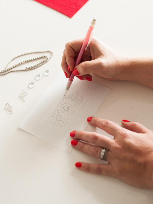 Sketch your design onto graph paper. Use the graph paper's lines to create a symmetrical design.