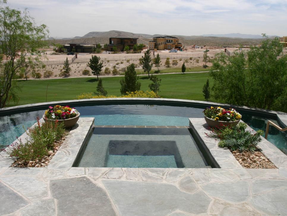 Pool with Raised Spa, Stone Planters and Golf Course View