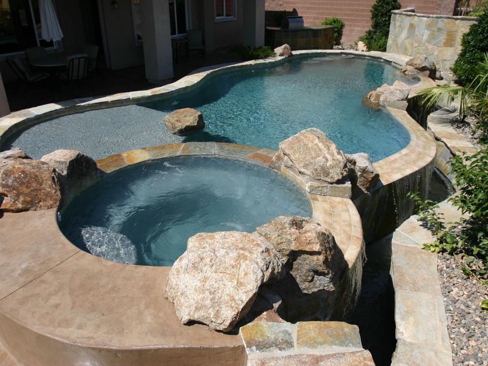 Raised Pool and Hot Tub With Irregular Boulders on the Edge