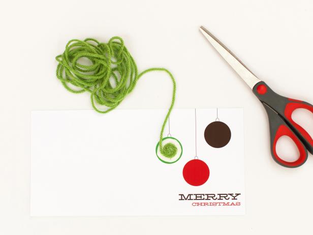 Apply glue to the first ornament, covering the entire circle. Place the end of the yarn in the center of the glue then wrap yarn in a circular motion, keeping each pass very close to the previous layer so none of the printed design below shows through.