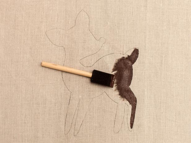 Use paint brush or foam brush to apply craft paint to pillow, filling in the traced area.