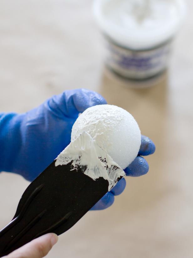 Apply Joint Compound to Styrofoam Ball with Putty Knife Apply Joint Compound to Styrofoam Ball with Putty Knife
