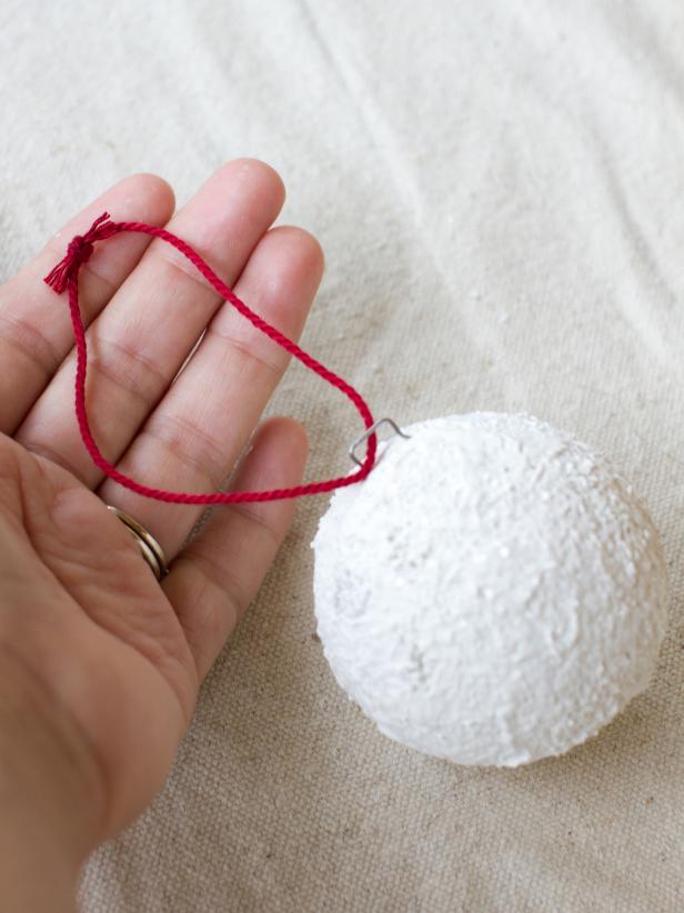 Loop twine through the pin and hang your finished ornaments on the tree.