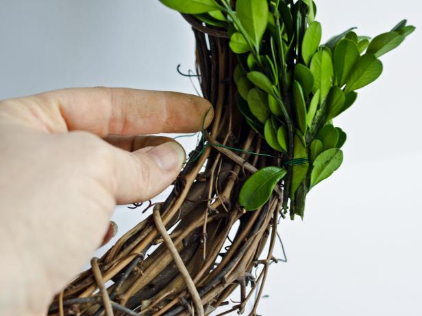 Pieces can either be wrapped around entire form or woven through the grapevine branches. Tie one bunch on the inside, one in the center and one on the outside.
