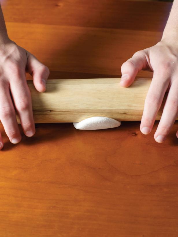 Tear off a piece of foam clay and roll it into a ball. Using a rolling pin, roll out the foam to about 1/4-inch thickness. Wrap the foam circle around the ball and pinch it together to completely cover the ball. Pinch away any excess.