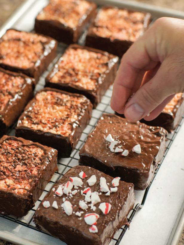 When cooled, loosen sides of pan with a knife and turn out onto a cutting board. Cut into 12 equally sized bars. Melt remaining chocolate chips in heatproof bowl. Spread melted chocolate onto sides and tops of bars and sprinkle with peppermint candy pieces. Allow to cool and harden completely before serving. Store in an airtight container.
